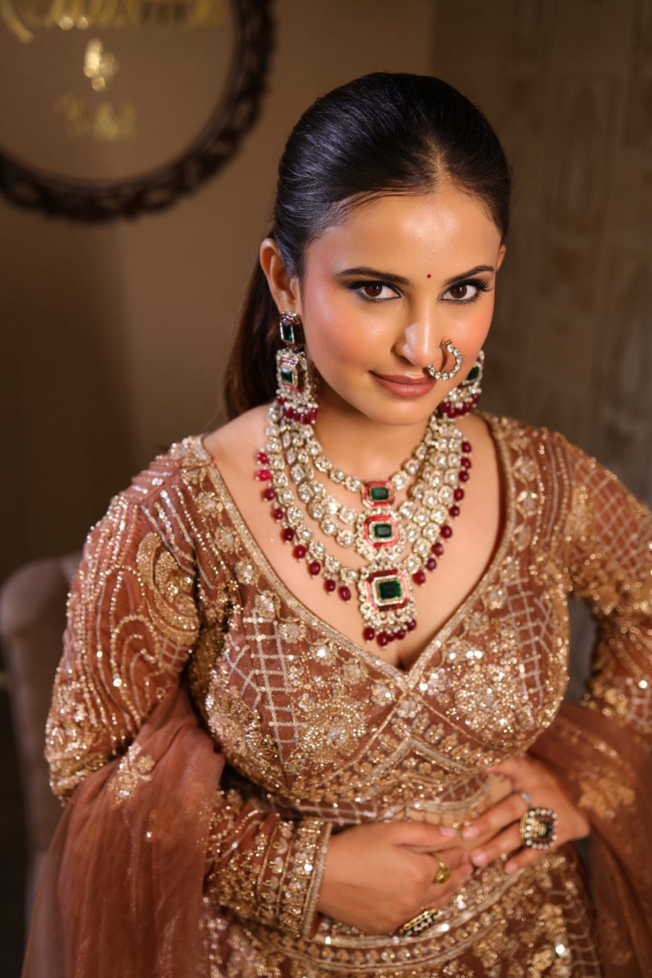 Bronze sequin lehenga with kundan and emerald jewellery