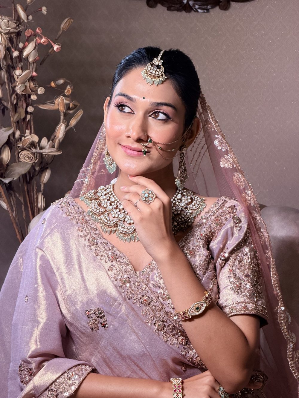Bride in a lavender lehenga with kundan jewellery and soft glam makeup